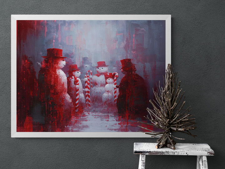 Surreal Christmas painting of snowmen in red hats holding candy canes, snowy gathering scene with bold red and gray tones.