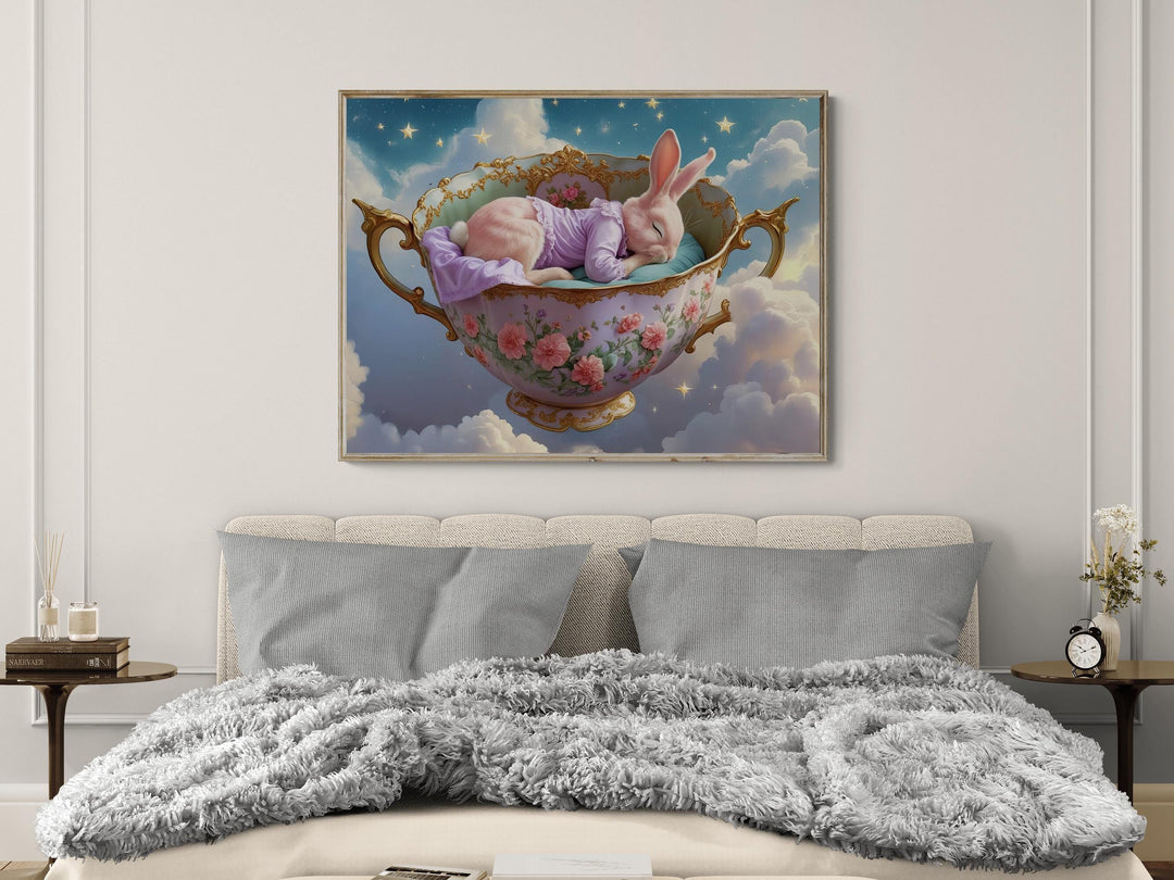 Dreamy fantasy artwork of a pink bunny peacefully sleeping in a gold-trimmed floral teacup floating among clouds and glowing stars — perfect nursery wall art for whimsical or celestial decor lovers.