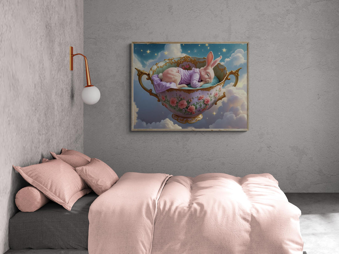 Dreamy fantasy artwork of a pink bunny peacefully sleeping in a gold-trimmed floral teacup floating among clouds and glowing stars — perfect nursery wall art for whimsical or celestial decor lovers.