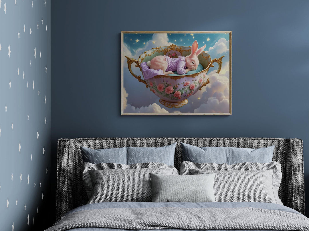 Whimsical art of pink bunny sleeping in a vintage teacup among clouds and stars.
