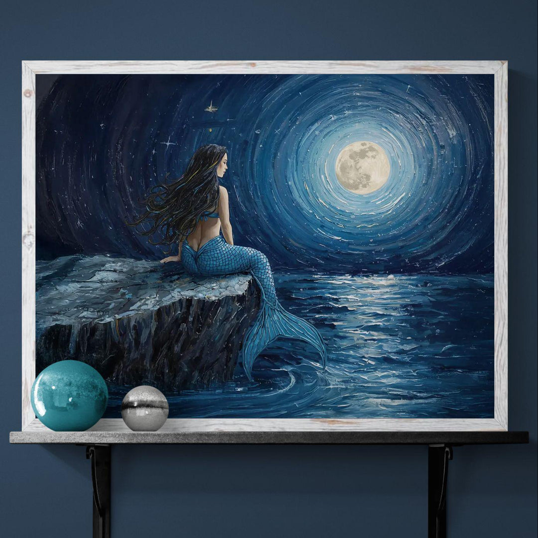 Night ocean mermaid wall art featuring a solitary mermaid seated by the sea at night beneath a glowing moon, painted in deep blue tones with a calm, mystical atmosphere
