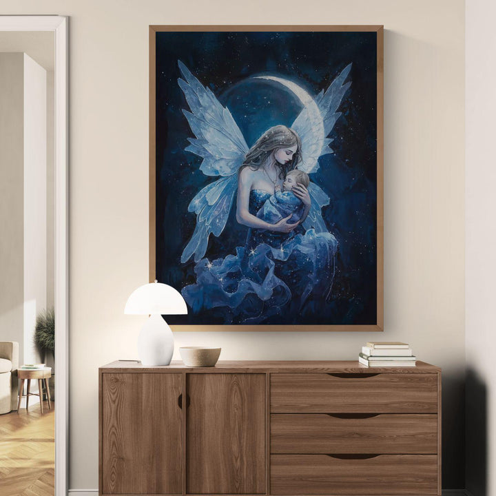 Celestial fairy mother wall art showing a winged mother holding her sleeping baby beneath a glowing moon and starry night sky, designed as peaceful nursery décor for new moms.