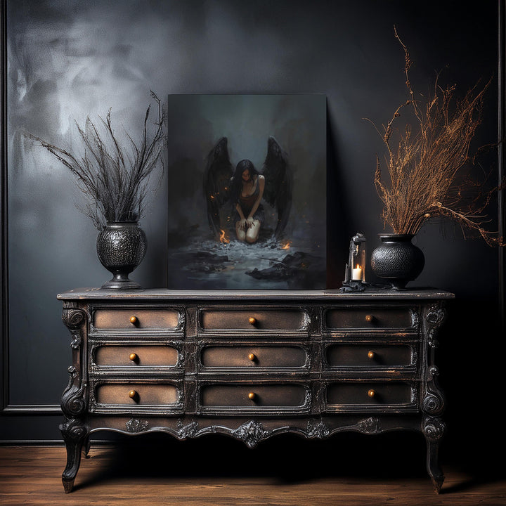 Gothic dark fantasy artwork of a fallen angel kneeling in ash with black wings, glowing embers, and sorrowful atmosphere