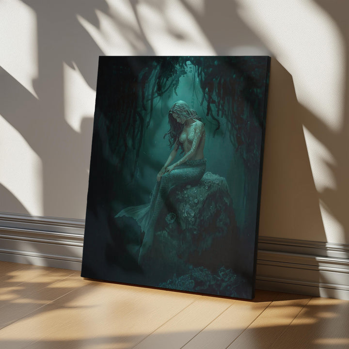 Dark mermaid wall art featuring a haunting siren seated beneath hanging kelp, glowing with teal magical markings in an underwater fantasy scene